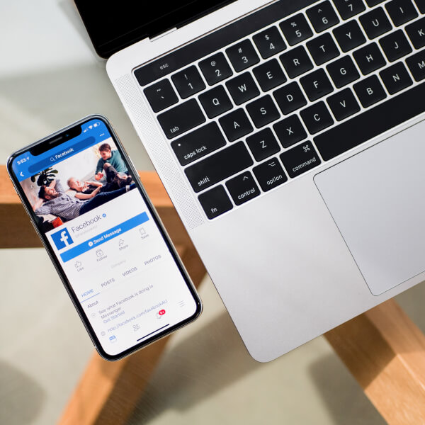 A phone and a computer showing a social media